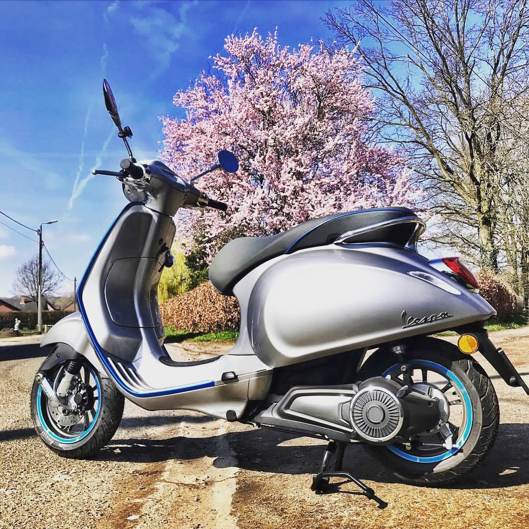 Vespa under a blossoming tree along the blossom route